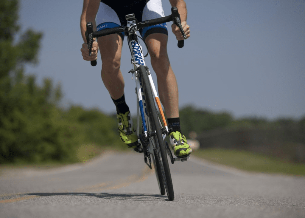 Man riding a bike down an empty street