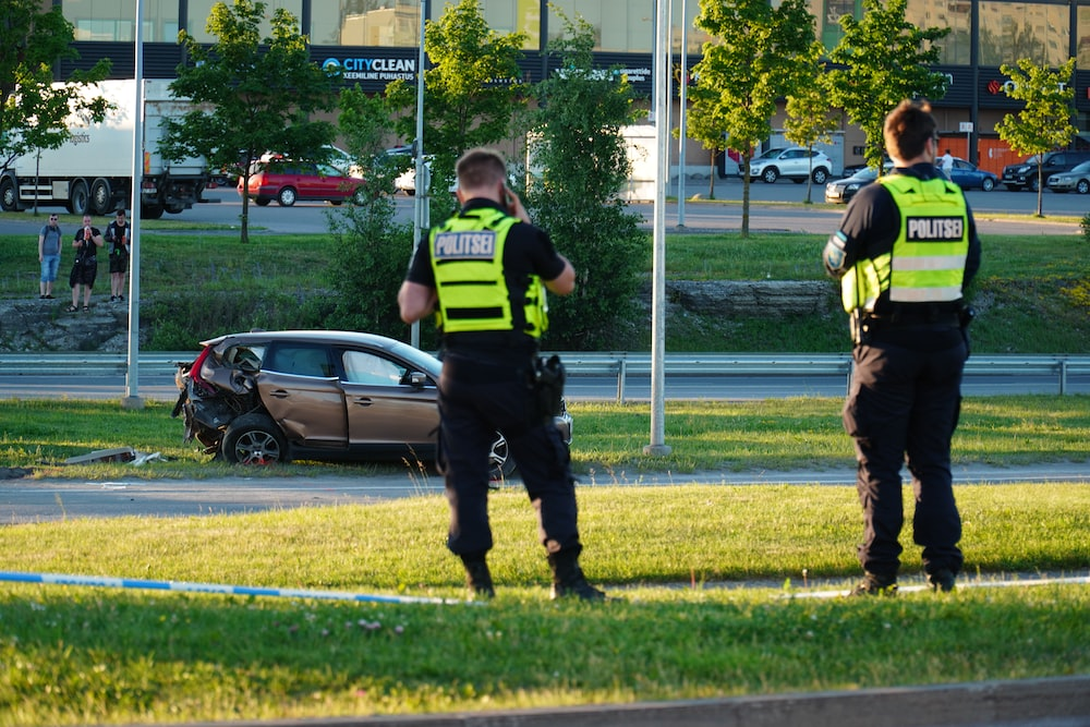 Two Law Enforcement Officers at the Scene of a Car Accident