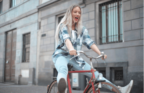 a woman riding a bike carelessly
