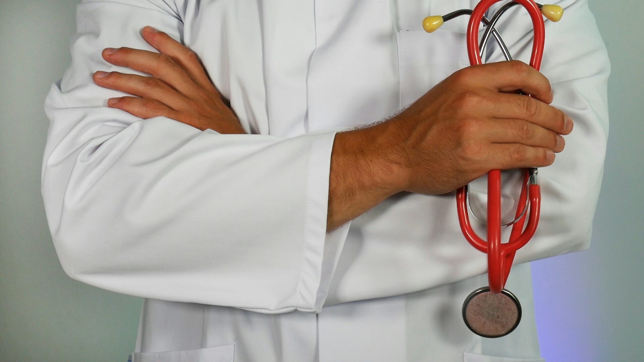 a doctor holding red stethoscope