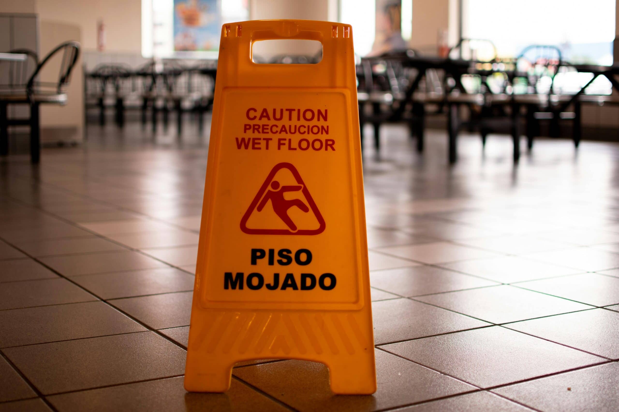 A caution "wet floor" sign to avoid a slip and fall lawsuit.